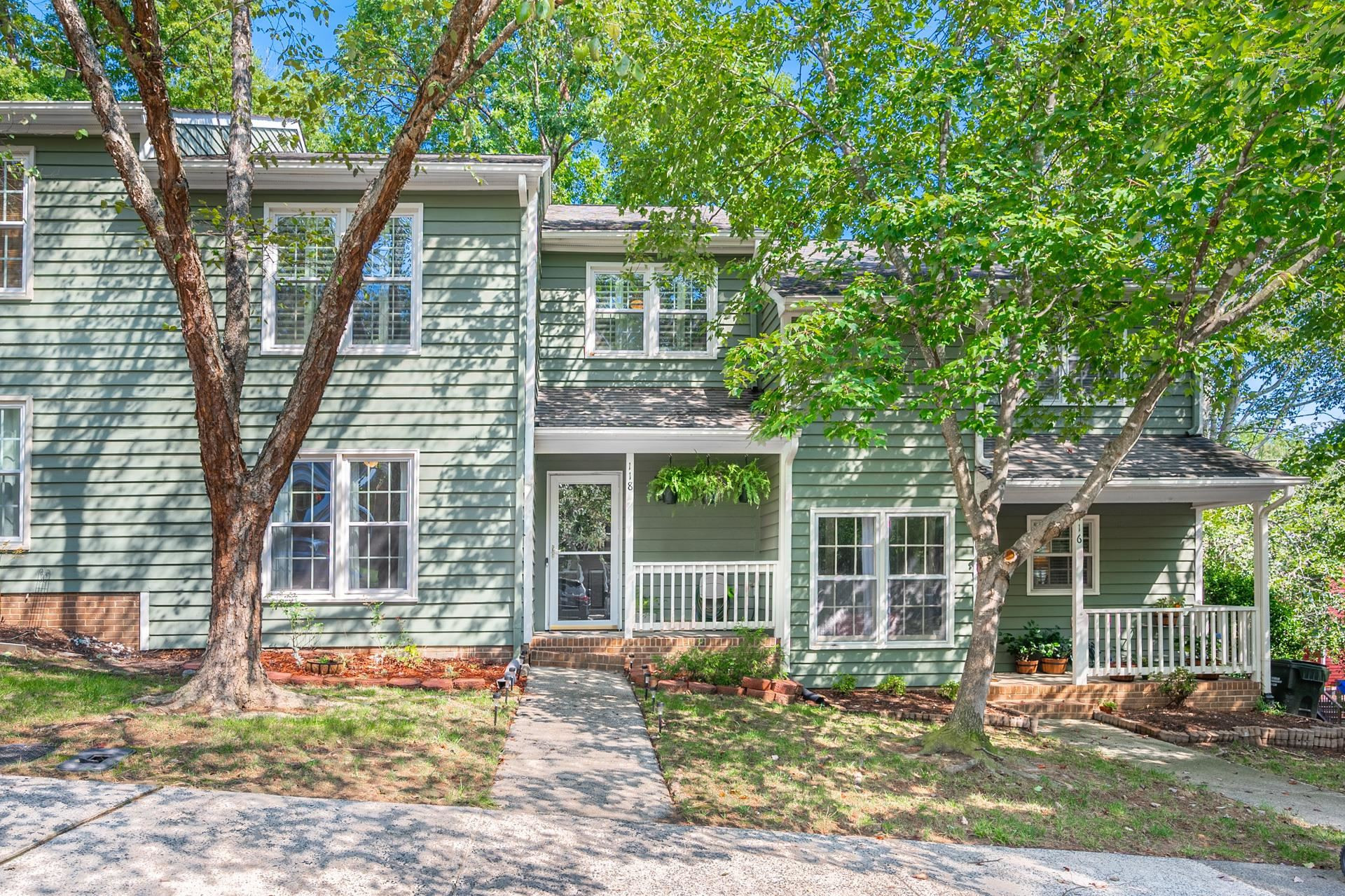 118 Long Shadow Place Durham, NC 27713 - Photo 1 of 24 a front view of a house with a yard and glass windows