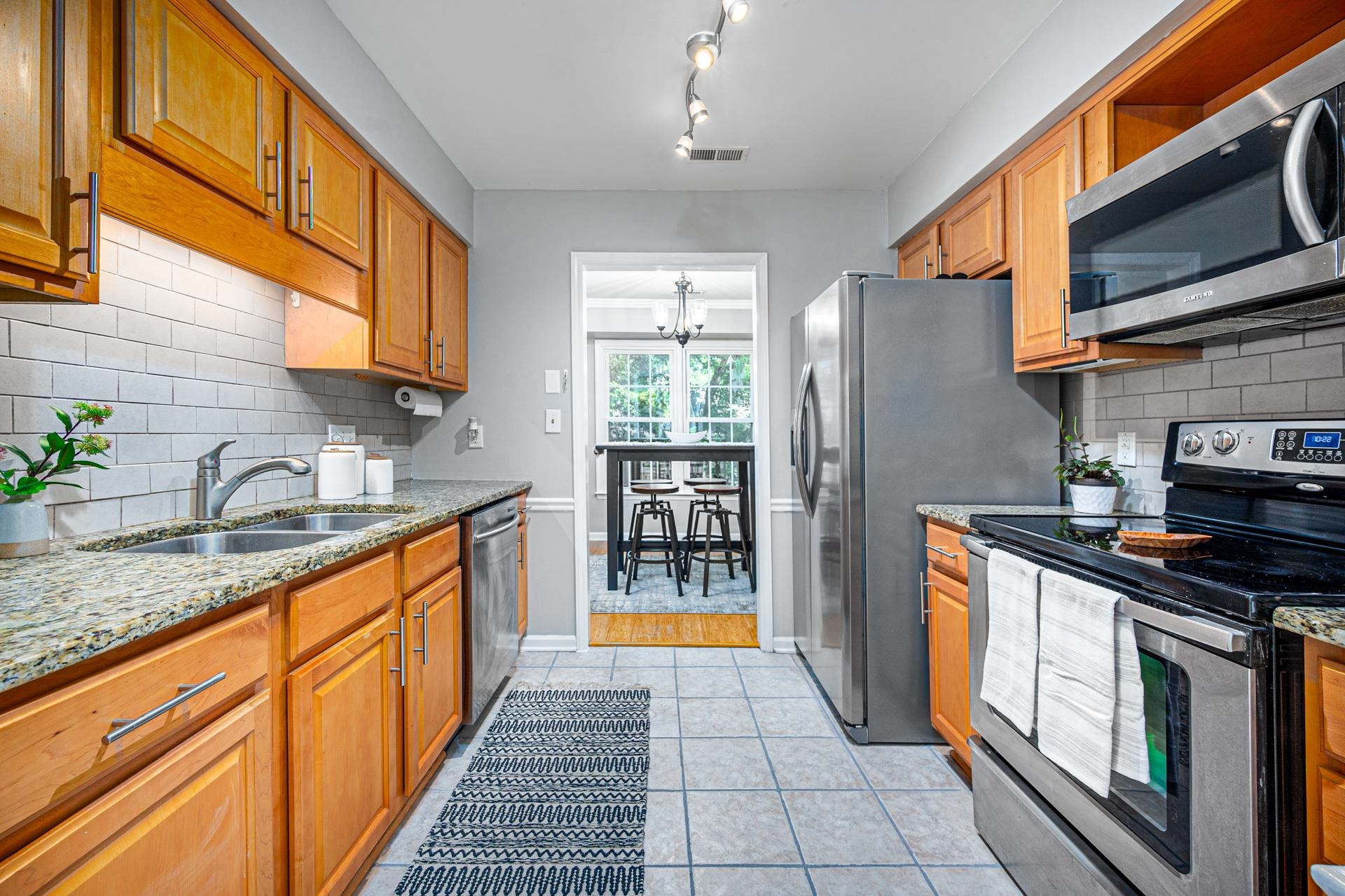 118 Long Shadow Place Durham, NC 27713 - Photo 7 of 24 a kitchen with stainless steel appliances granite countertop a stove a sink and a microwave