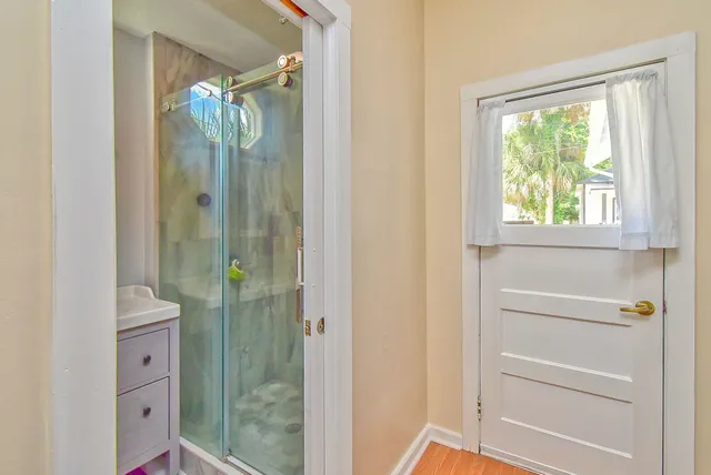 a bathroom with a glass shower door and a sink