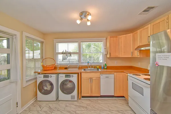 a utility room with sink dryer and washer