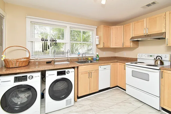 a kitchen with a stove top oven sink and cabinets
