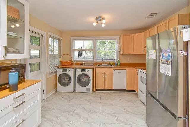 a kitchen with a stove top oven sink and cabinets