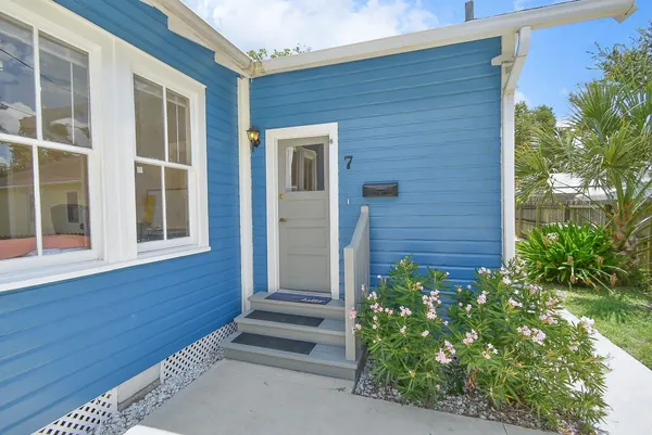 a view of house with entryway and wooden floor