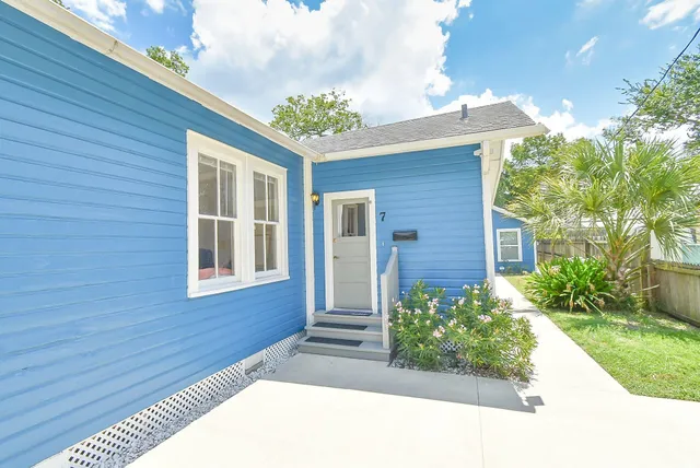 a front view of a house with a garden