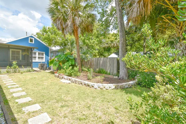 a view of backyard with plants and outdoor seating