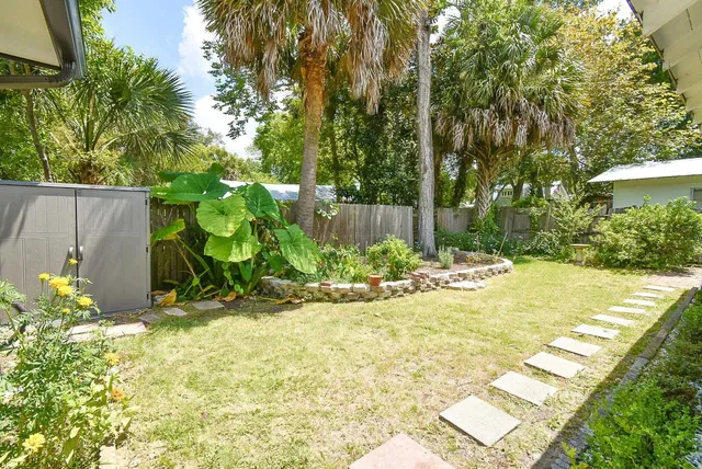 a front view of house with yard and trees around
