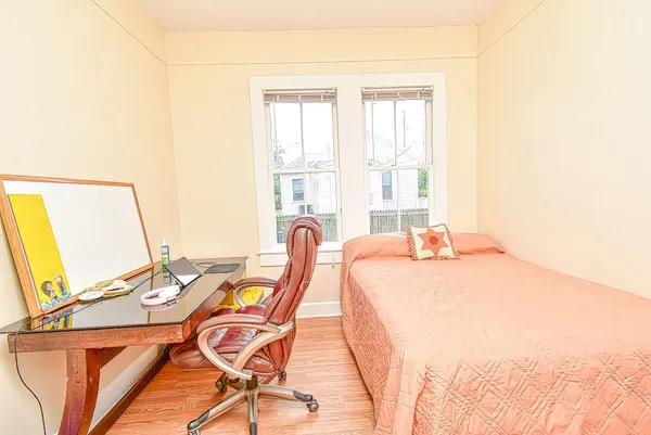 a bed sitting in a bedroom next to a window