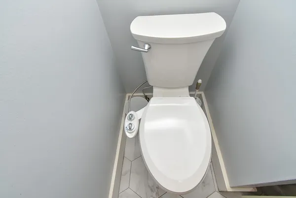 a white toilet sitting next to a white sink