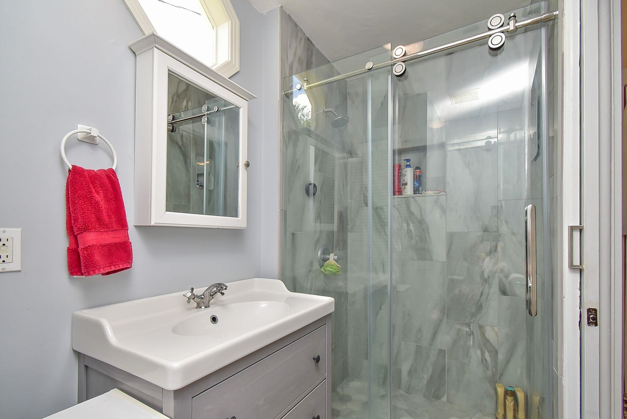 7 Dupont Lane St. Augustine, FL 32084 - Photo 9 of 39 a bathroom with a sink vanity and mirror