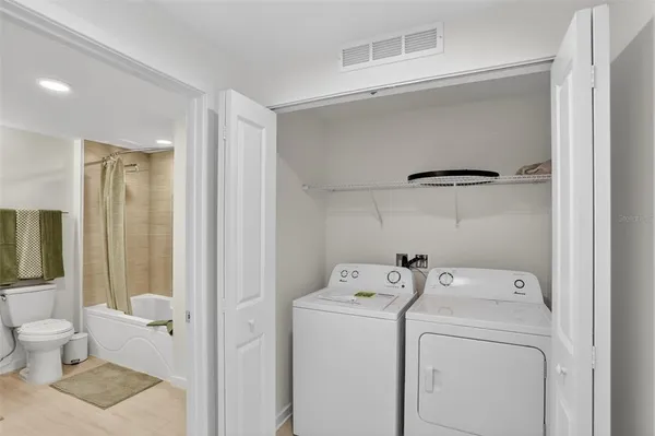 a view of bathroom with a washer and dryer