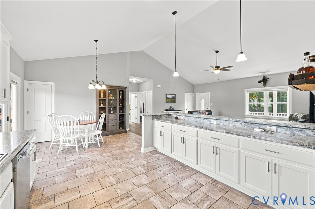 8718 Rock Cedar Road New Kent, VA 23124 - Photo 16 of 43 Open-concept kitchen with white cabinetry and ligh