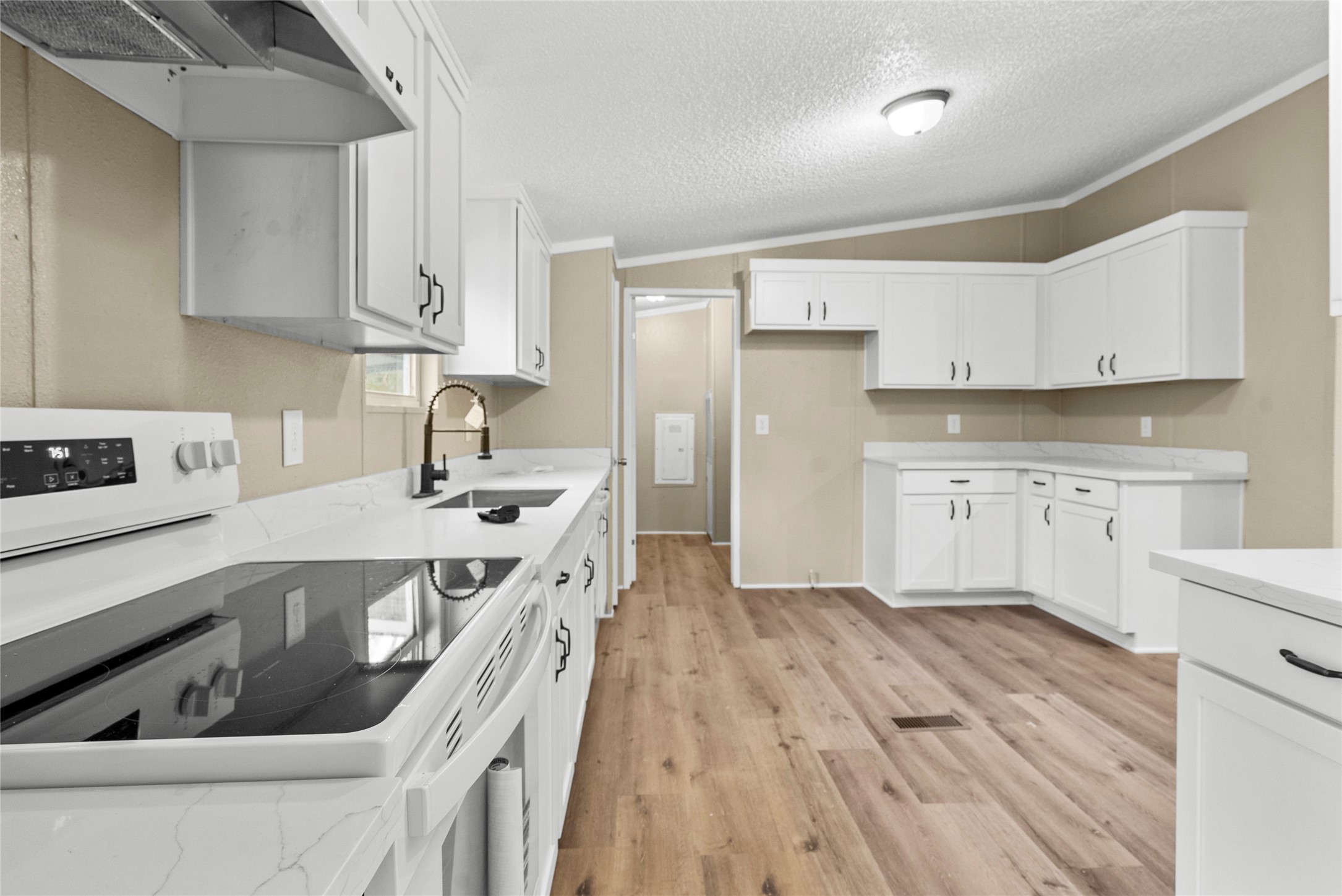12902 Indian Ridge Drive Dayton, TX 77535 - Photo 11 of 31 a kitchen with stainless steel appliances granite countertop a sink dishwasher a refrigerator and white cabinets with wooden floor