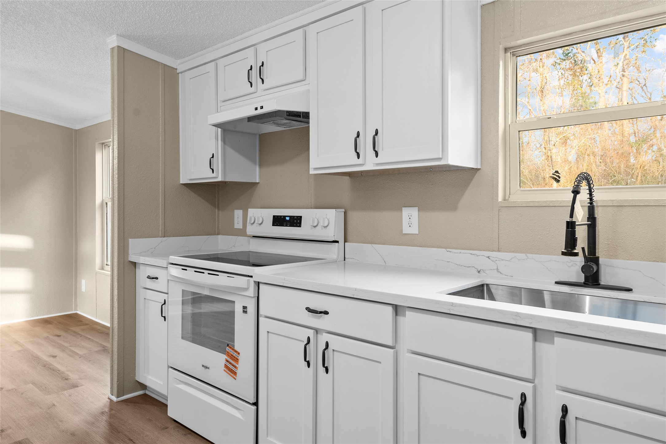 12902 Indian Ridge Drive Dayton, TX 77535 - Photo 13 of 31 a kitchen with white cabinets and a stove top oven