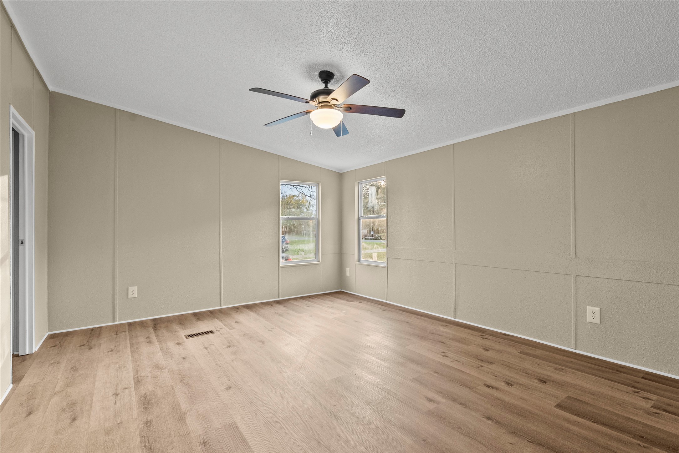 12902 Indian Ridge Drive Dayton, TX 77535 - Photo 15 of 31 a view of empty room with wooden floor and fan
