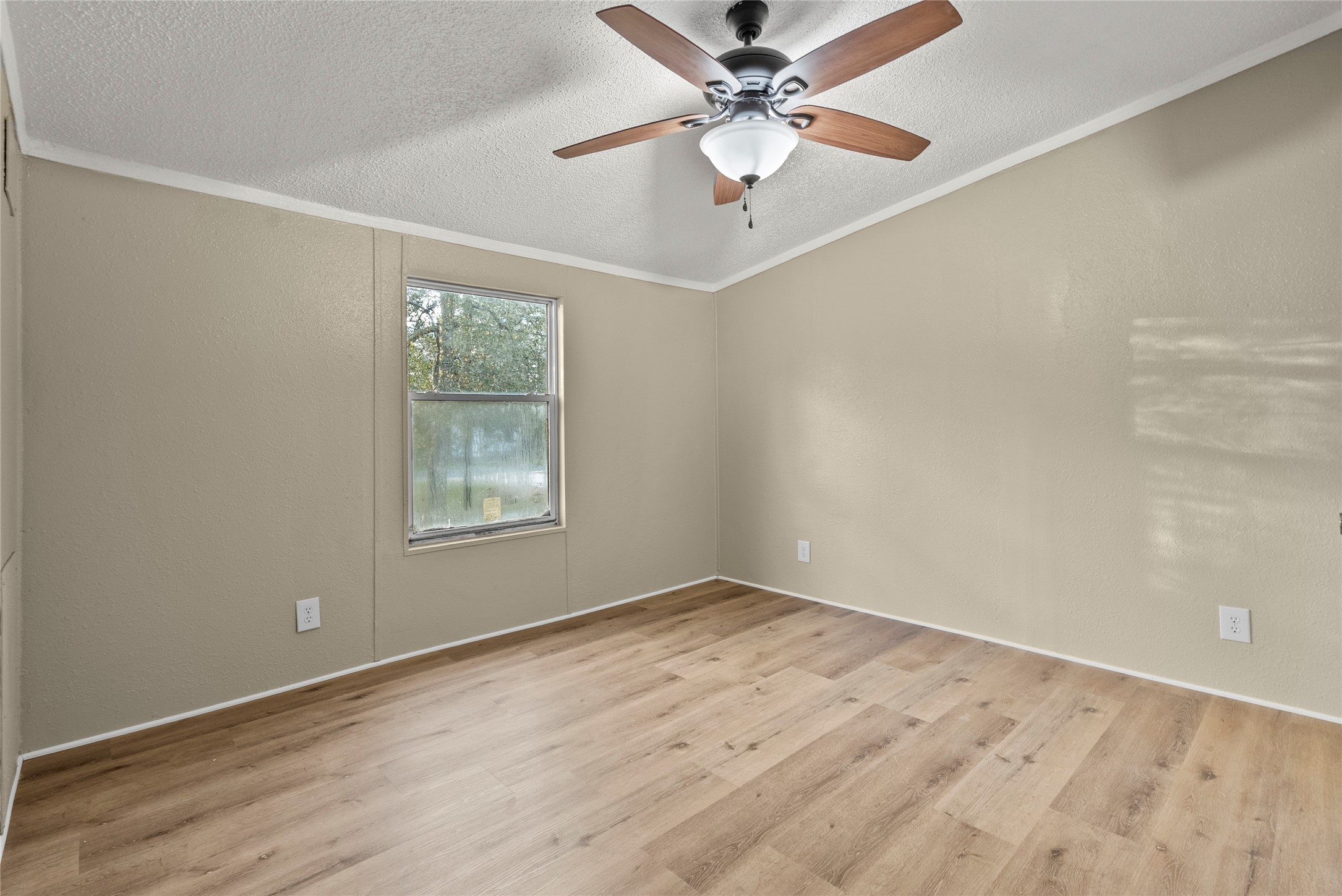 12902 Indian Ridge Drive Dayton, TX 77535 - Photo 16 of 31 an empty room with a window and a fan