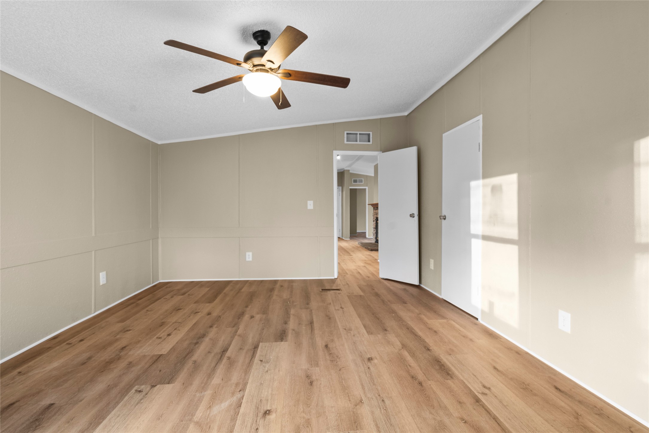 12902 Indian Ridge Drive Dayton, TX 77535 - Photo 17 of 31 an empty room with wooden floor and a ceiling fan