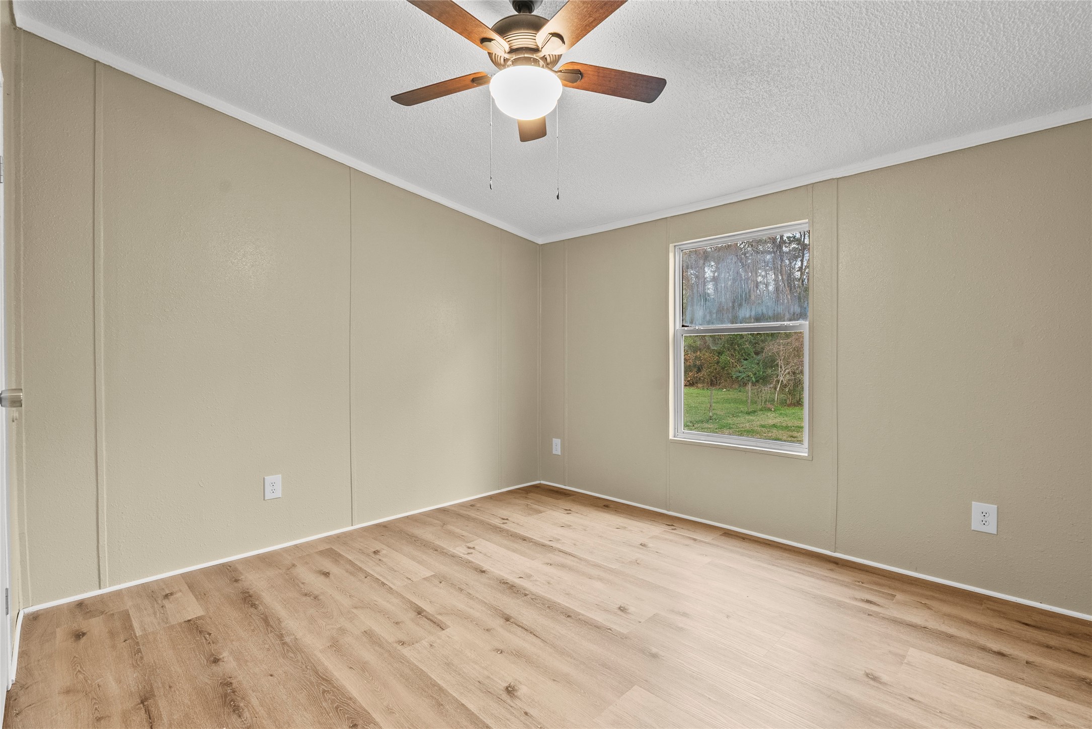 12902 Indian Ridge Drive Dayton, TX 77535 - Photo 22 of 31 a view of an empty room with window and a chandelier fan