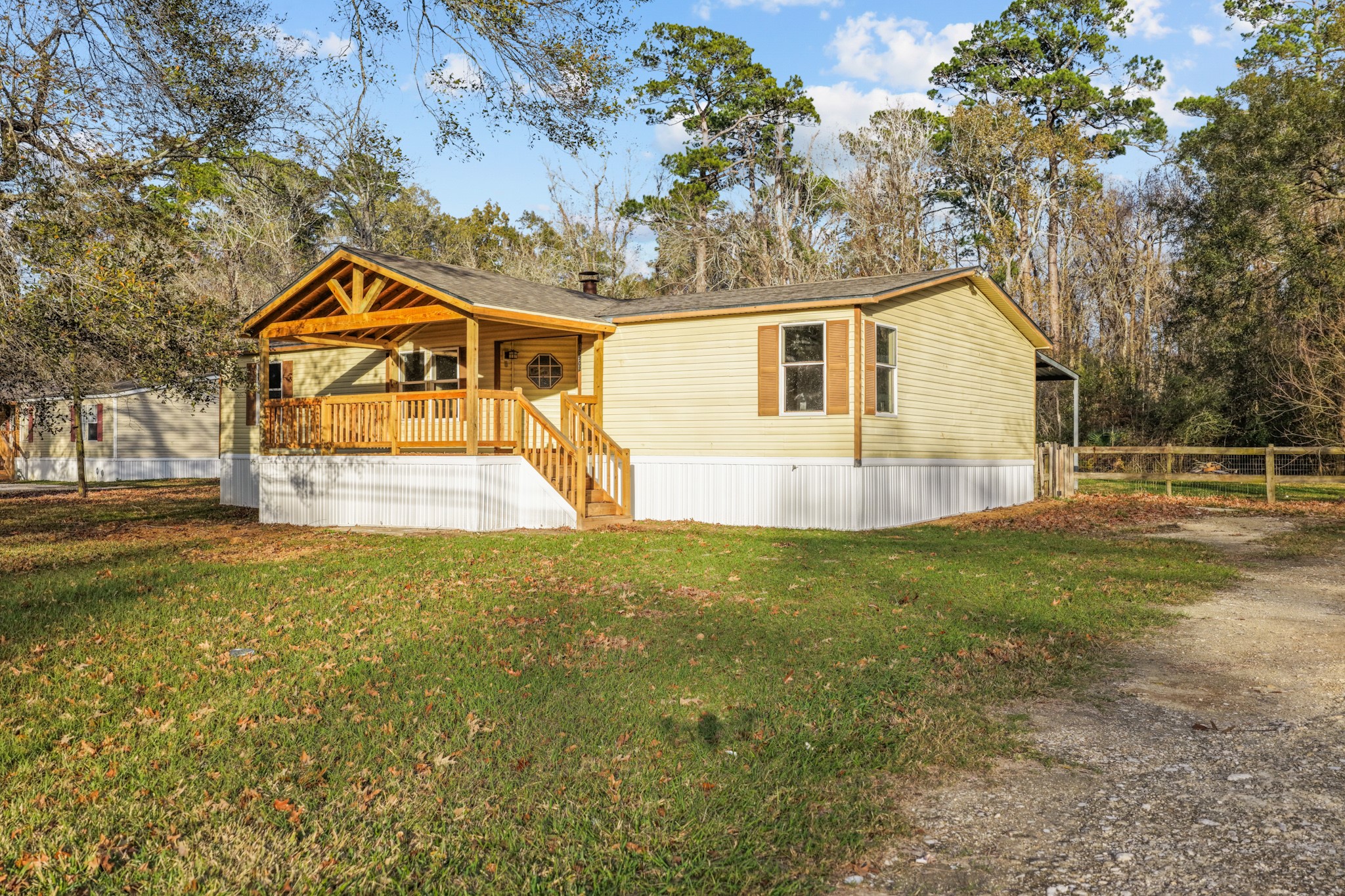 12902 Indian Ridge Drive Dayton, TX 77535 - Photo 4 of 31 a view of a yard in front of a house with a large tree