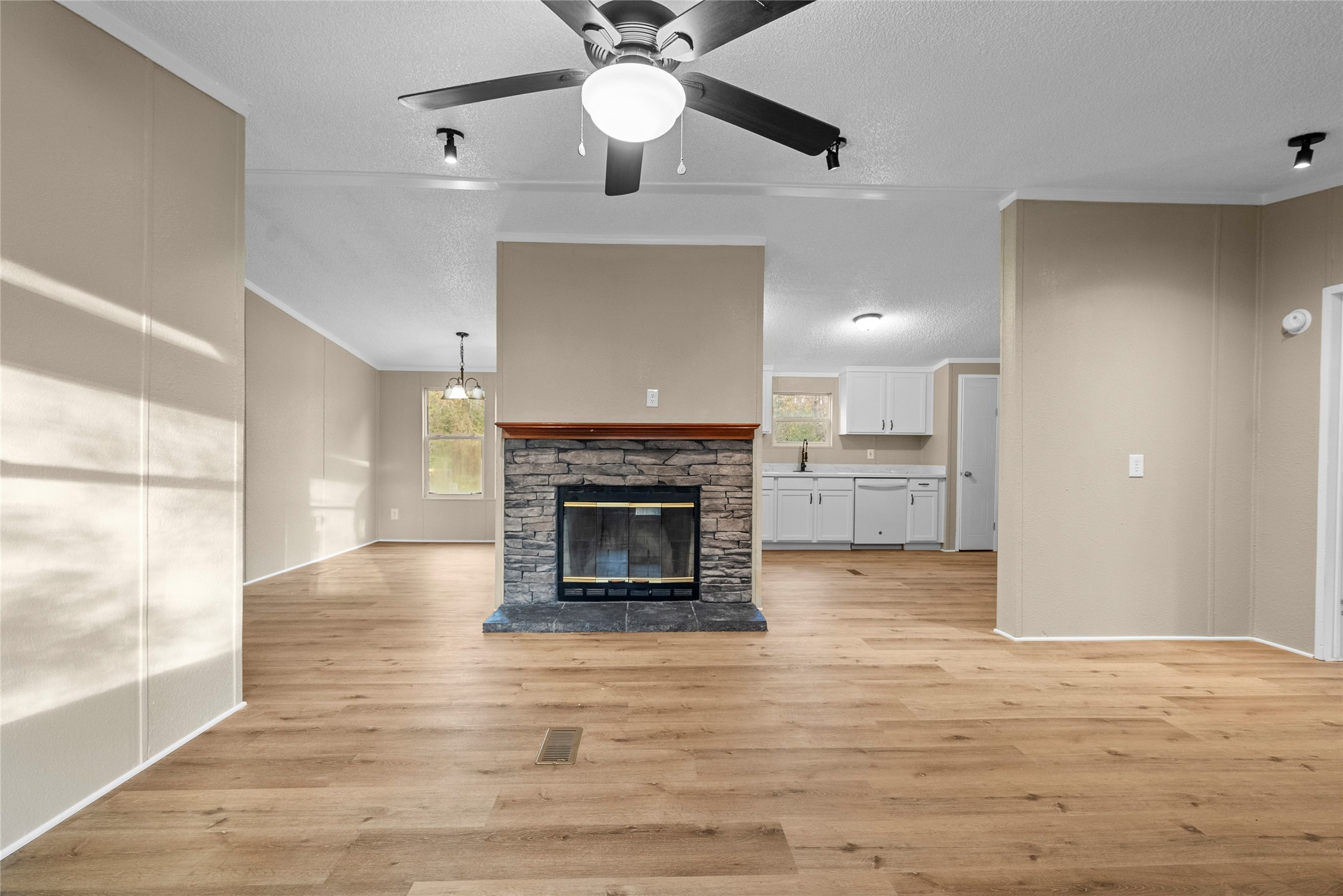 12902 Indian Ridge Drive Dayton, TX 77535 - Photo 8 of 31 a view of a livingroom with a fireplace a ceiling fan and wooden floor