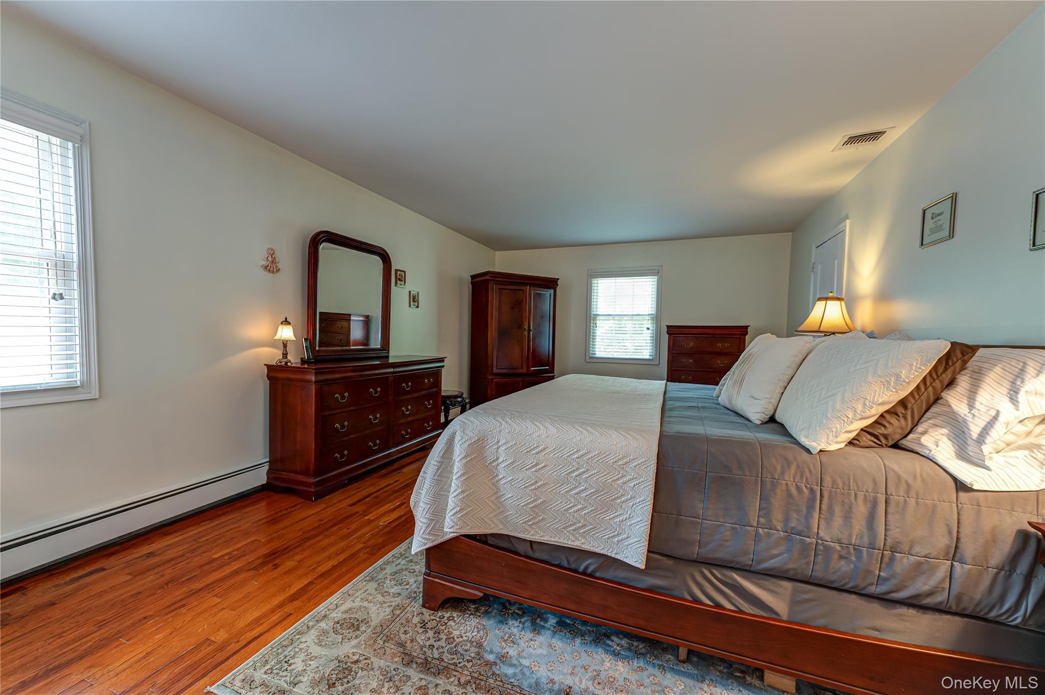 3 Thompson Hill Road St. James, NY 11780 - Photo 15 of 34 a bedroom with a bed and a dresser