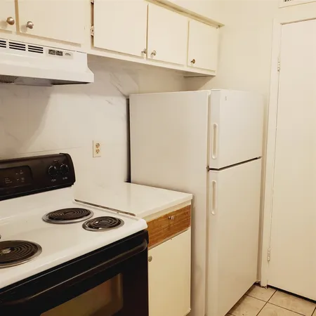 a kitchen with a stove and a refrigerator