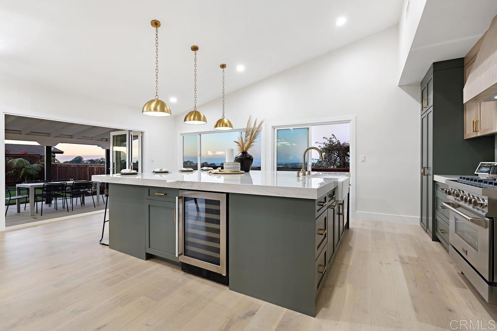14224 Recuerdo Drive Del Mar, CA 92014 - Photo 7 of 21 a kitchen with stainless steel appliances kitchen island granite countertop a sink a stove and a wooden floors