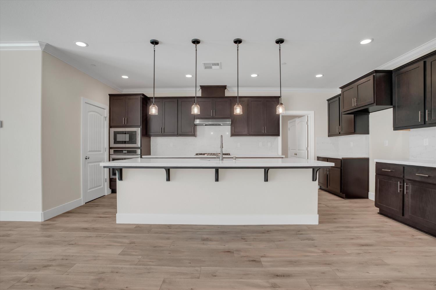 1898 Sanza Road Manteca, CA 95337 - Photo 11 of 41 a view of kitchen with stainless steel appliances refrigerator stove microwave and cabinets