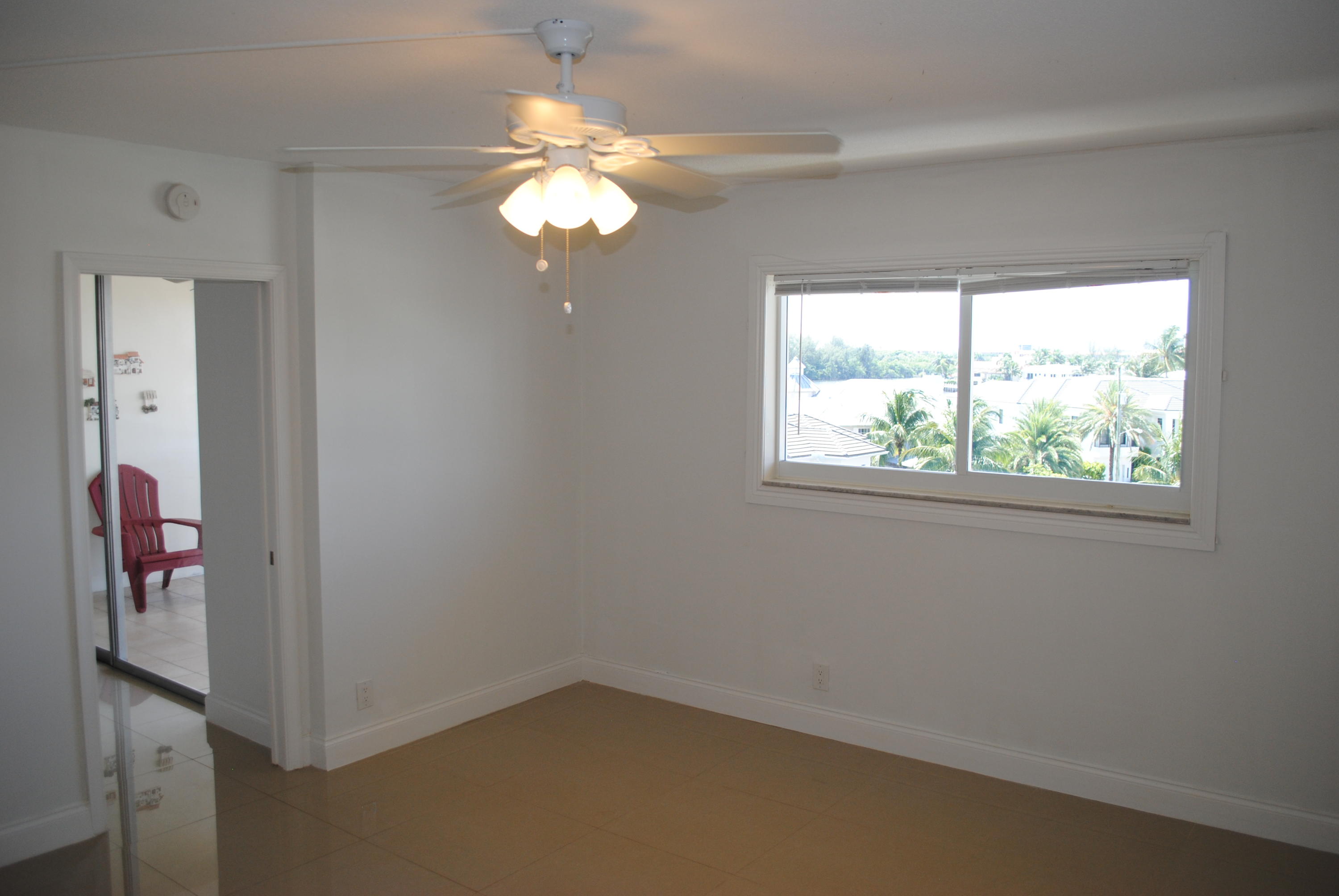 750 Northeast Spanish River Boulevard, Unit 503 Boca Raton, FL 33431 - Photo 17 of 32 wooden floor in an empty room with a window