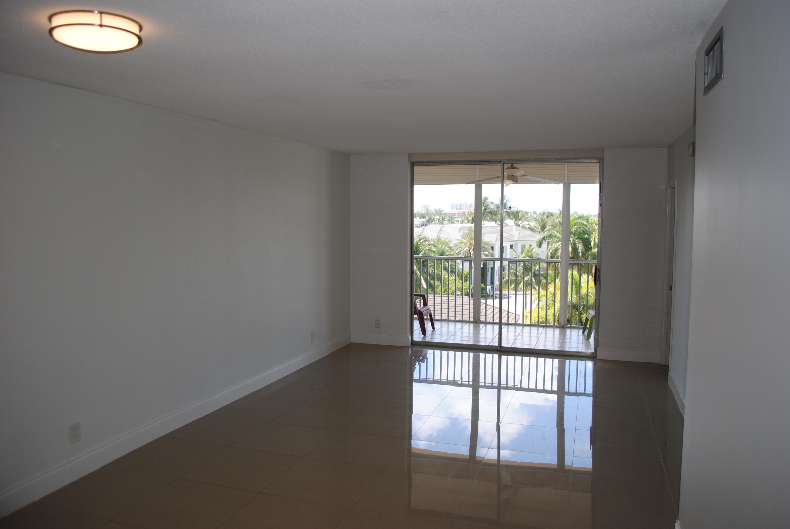 750 Northeast Spanish River Boulevard, Unit 503 Boca Raton, FL 33431 - Photo 18 of 32 a view of empty room with wooden floor and fan