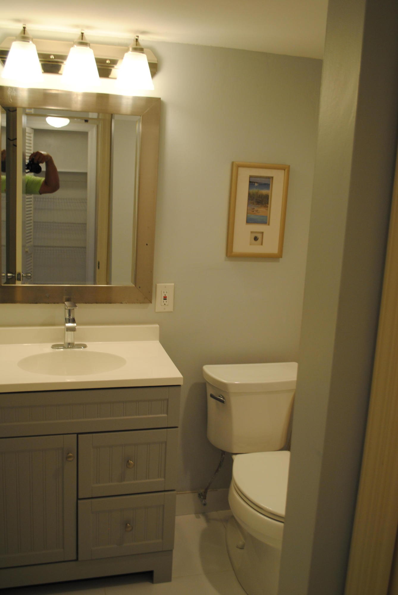 750 Northeast Spanish River Boulevard, Unit 503 Boca Raton, FL 33431 - Photo 21 of 32 a bathroom with a toilet a sink and mirror