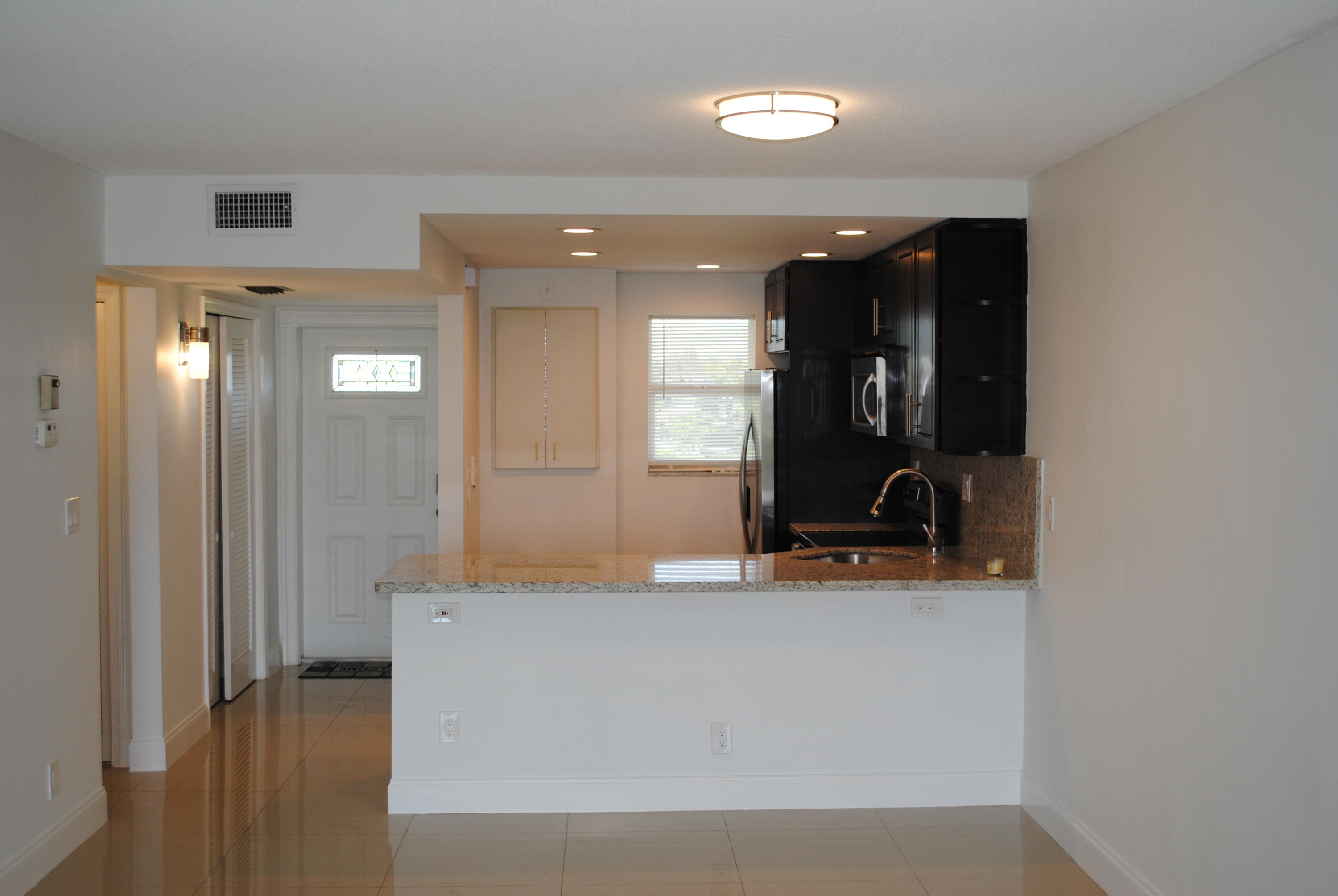 750 Northeast Spanish River Boulevard, Unit 503 Boca Raton, FL 33431 - Photo 4 of 32 a view of a living room with bathroom