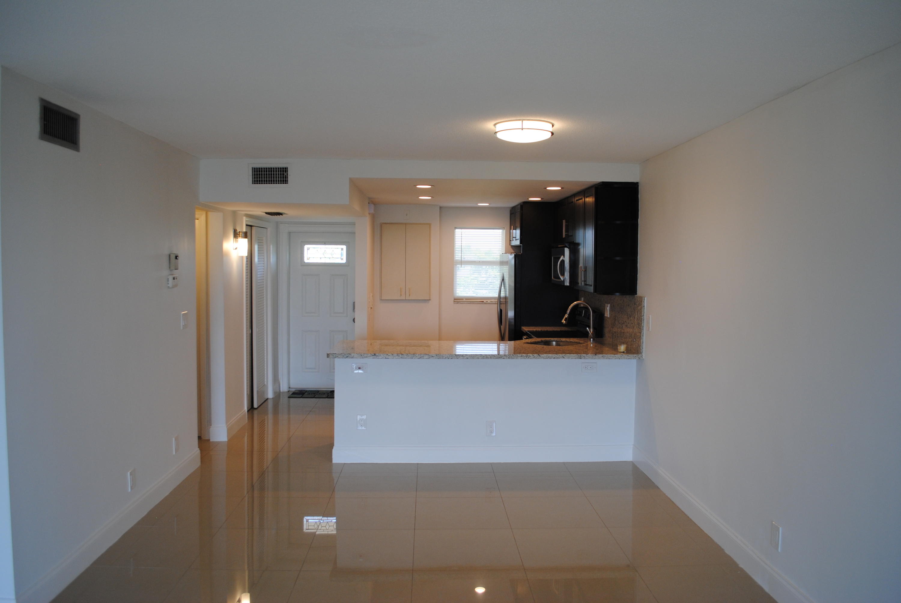750 Northeast Spanish River Boulevard, Unit 503 Boca Raton, FL 33431 - Photo 5 of 32 a view of a hallway with seating area
