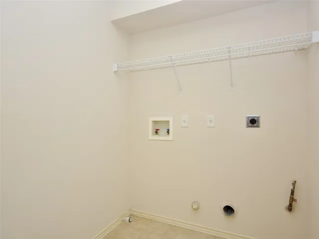 a kitchen with stainless steel appliances granite countertop a sink a stove a refrigerator a white cabinets and window