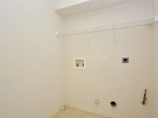 a kitchen with stainless steel appliances granite countertop a sink a stove a refrigerator a white cabinets and window