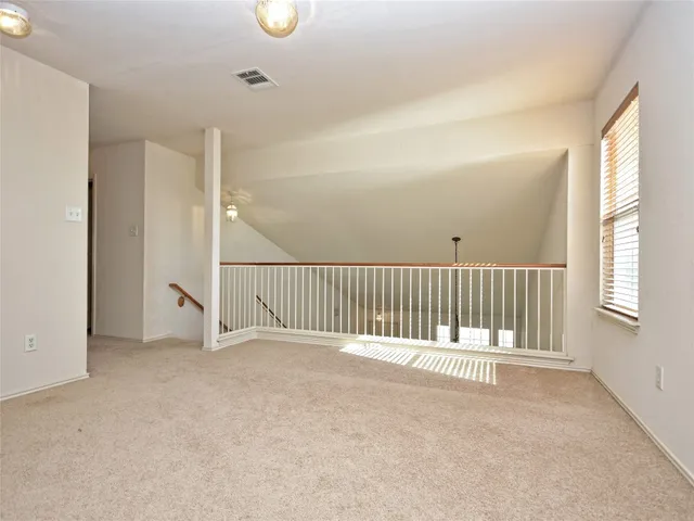 a view of a kitchen with refrigerator and window