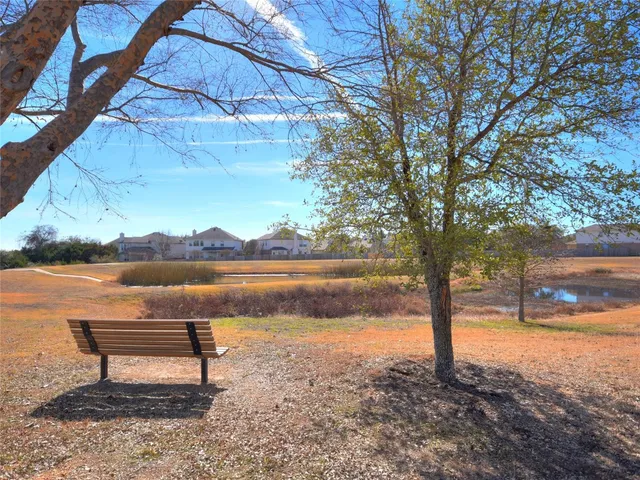 a view of a swimming pool with an outdoor seating and a yard