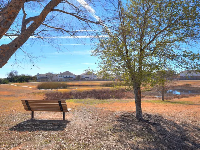 a view of a swimming pool with an outdoor seating and a yard
