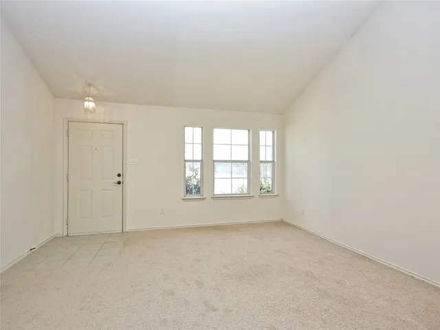an empty room with a empty space and windows