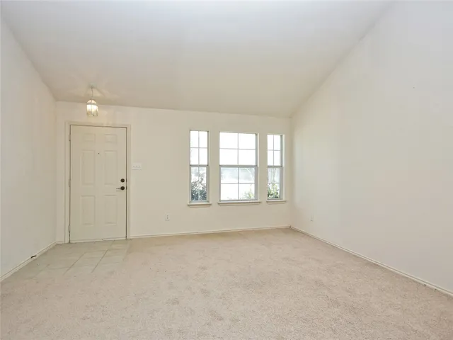 an empty room with a empty space and windows
