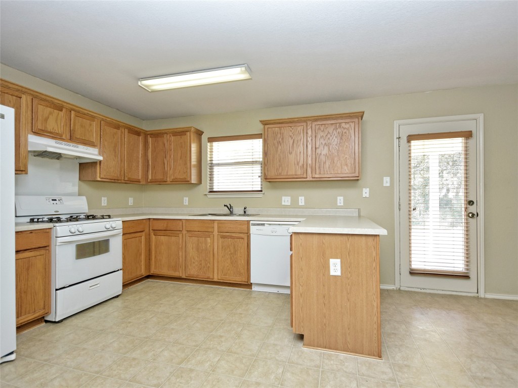 3600 Spring Canyon Trail Round Rock, TX 78681 - Photo 10 of 30 a kitchen with granite countertop white cabinets and white appliances