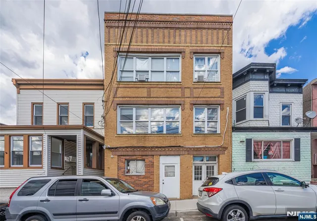 a front view of a building with parking space