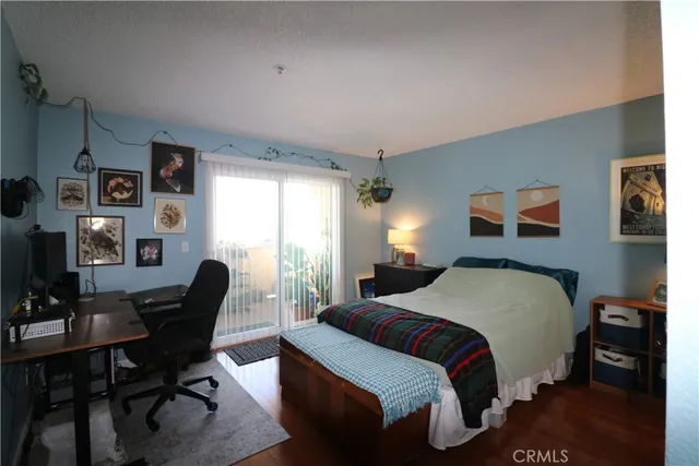 a bedroom with a bed and a desk