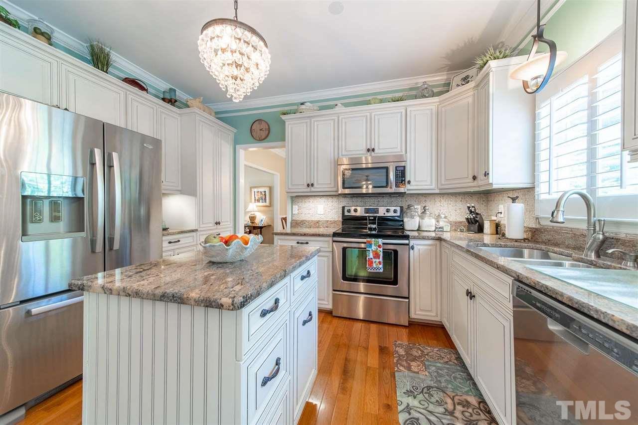10001 Duval Street Raleigh, NC 27614 - Photo 4 of 19 Wonderfully updated kitchen! Granite, tile backsplash, updated lighting and soft close cabinets with helpful pull outs!