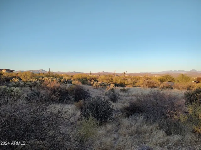 a view of a mountain range with lush green forest