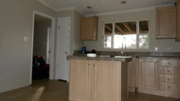 a kitchen with granite countertop a sink and a stove top oven