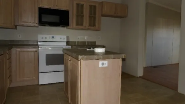 a kitchen with stainless steel appliances granite countertop a stove a microwave a sink and cabinets