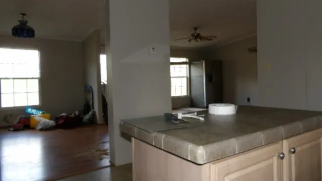 a kitchen with a table chairs and a window