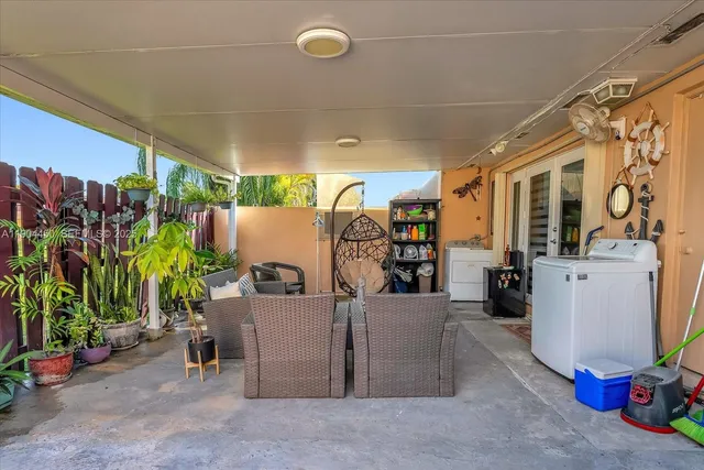 an aerial view of a residential houses with outdoor space and a street view