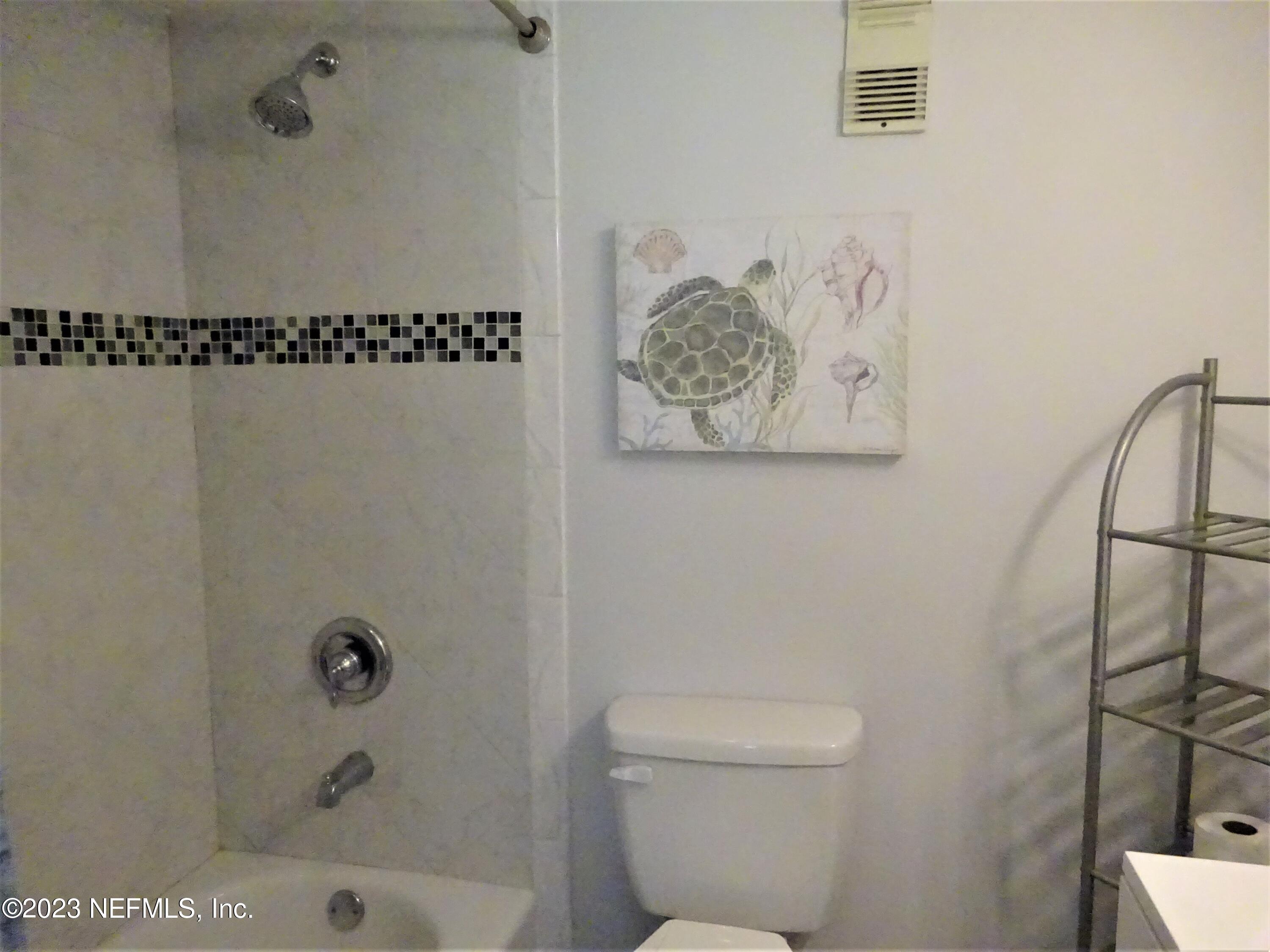 7175 A1A South, Unit F141 St. Augustine, FL 32080 - Photo 13 of 36 a bathroom with a toilet and a shower