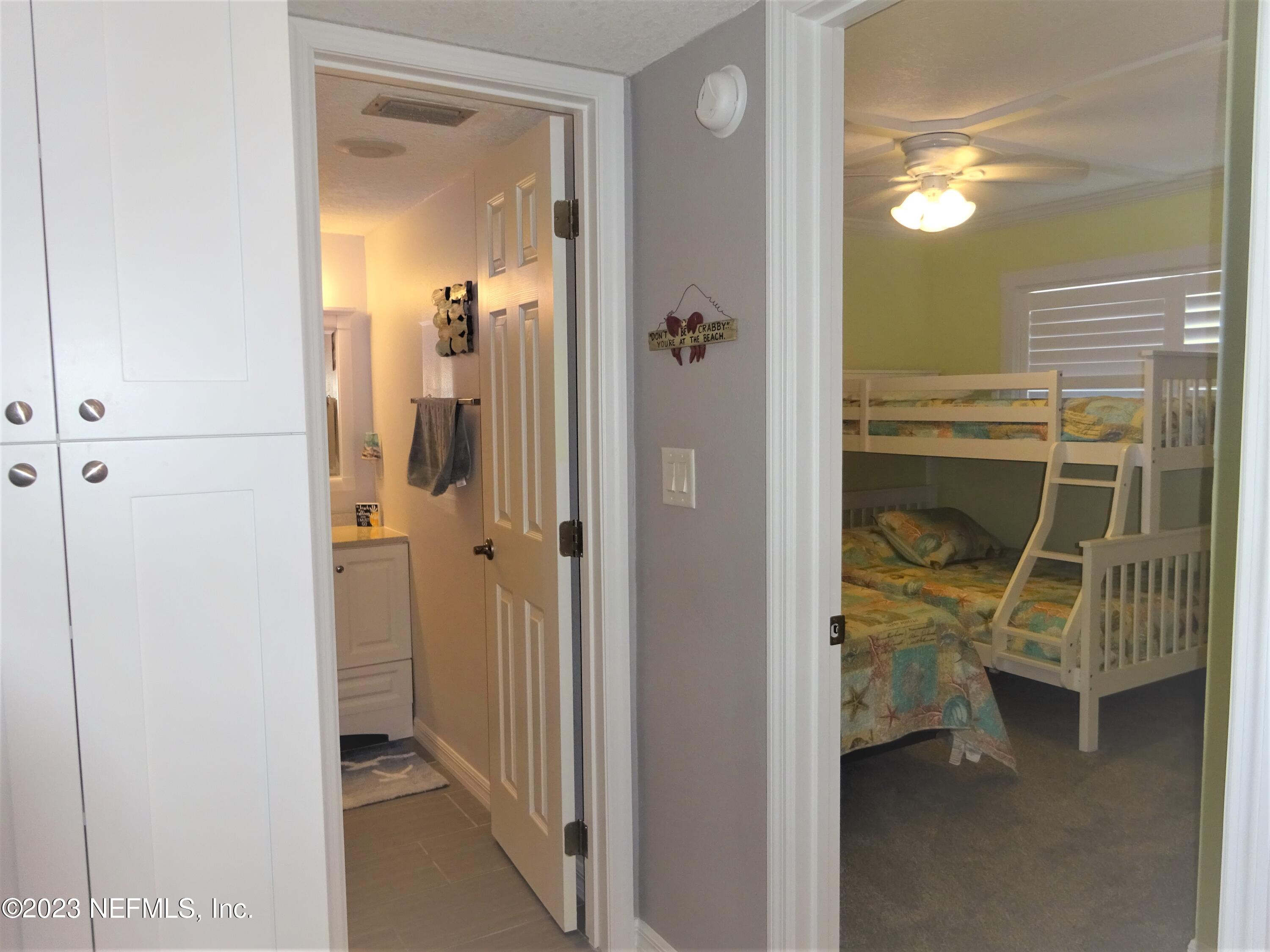 7175 A1A South, Unit F141 St. Augustine, FL 32080 - Photo 15 of 36 a view of a walk in closet and bathroom